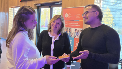 The Regional Field Coordinators chat with an attendee at the National Managers Community Connect Day.