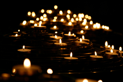 A darkened room filled with the gentle glow of candles