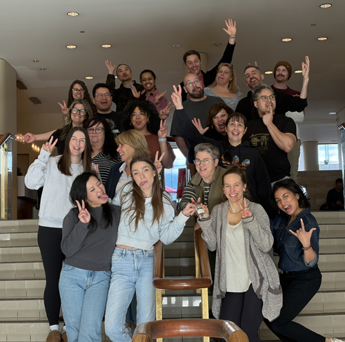The group poses on a set of stairs, making silly face and silly gestures