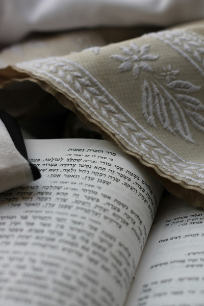 Close-up shot of the Torah and a prayer shawl